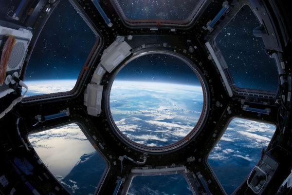 foto: View from cupola module porthole of ISS space station on Earth and outer space. Sci-fi collage. Elements of this image furnished by NASA // fot. Dima Zel, Ukraina / shutterstock.com